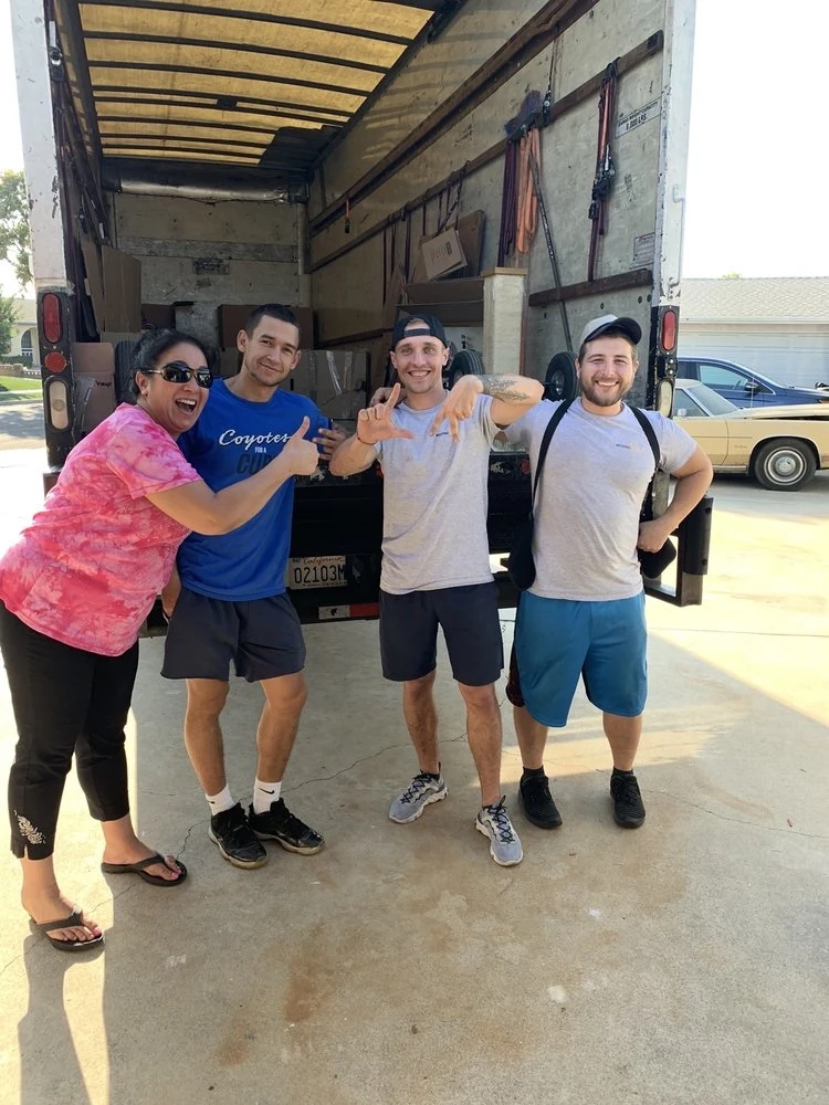 The KF Moving team and customers beside a moving truck